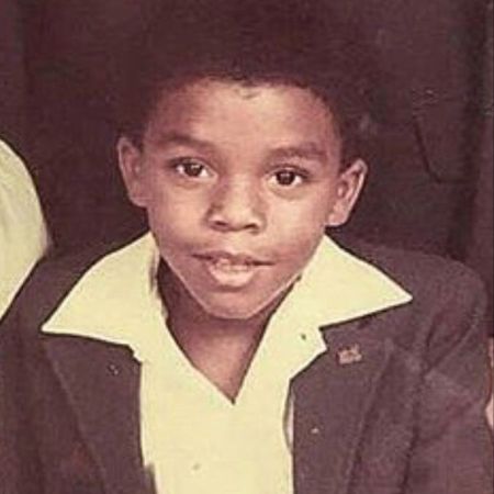 A young Chadwick Boseman wearing a suit